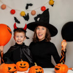 Family fun. Mother and Son Having Fun and Celebrating Halloween in Witch and Devil Costume
