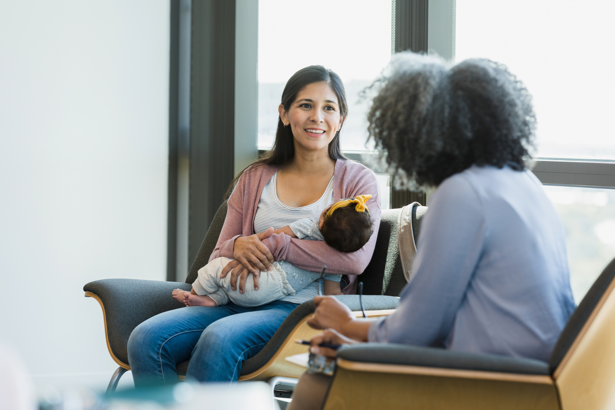 As therapist speaks, new mom smiles