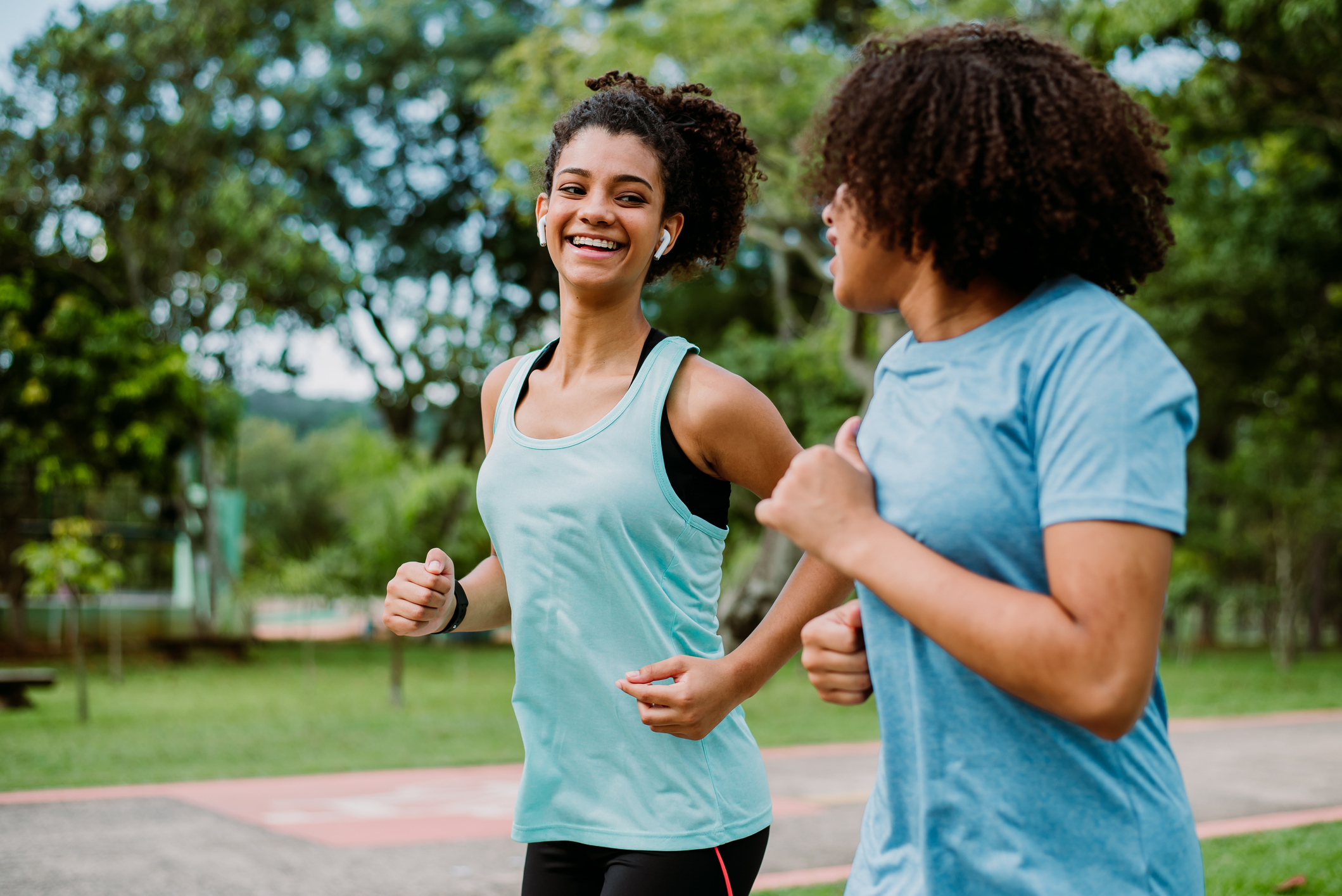 Two teenage friends running, exercising