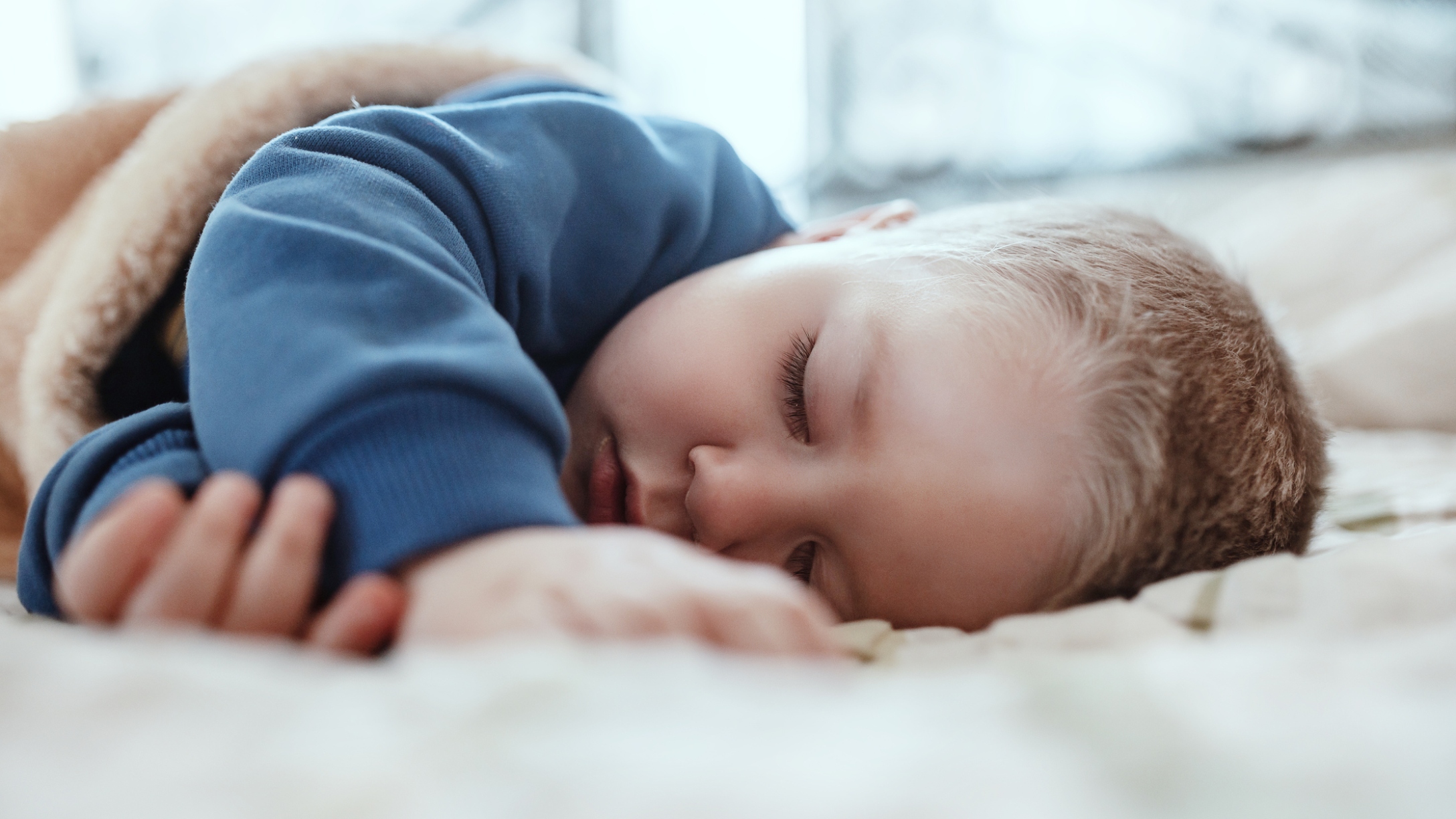 Toddler sleeping soundly in bed