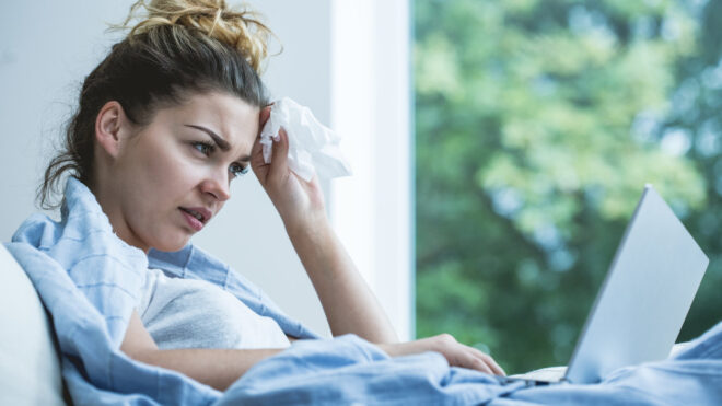 woman sick looking at computer