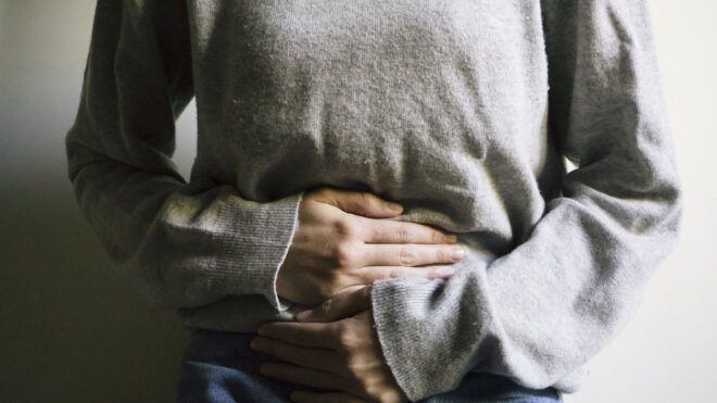 woman holding stomach