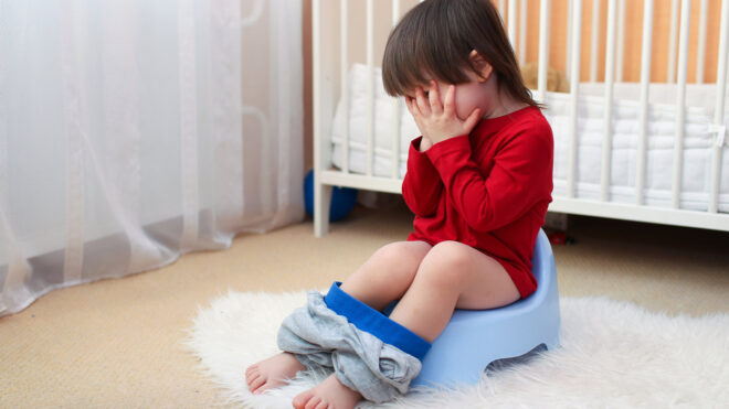 toddler sitting on potty