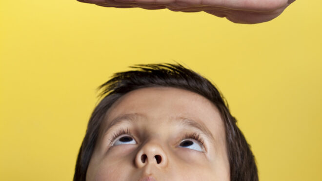 little boy getting height measured