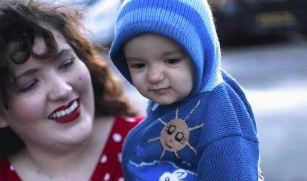 smiling plus size mom and baby