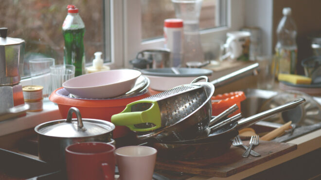 dirty dishes by a kitchen sink