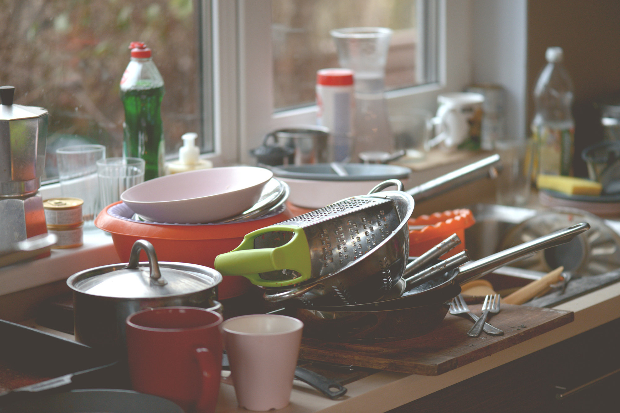 dirty dishes by a kitchen sink