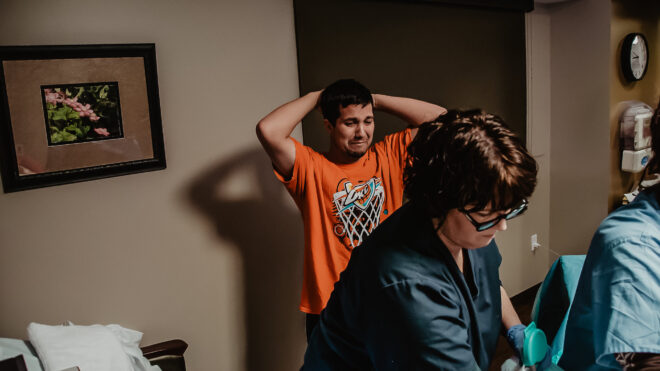 Man crying while his wife is in labor