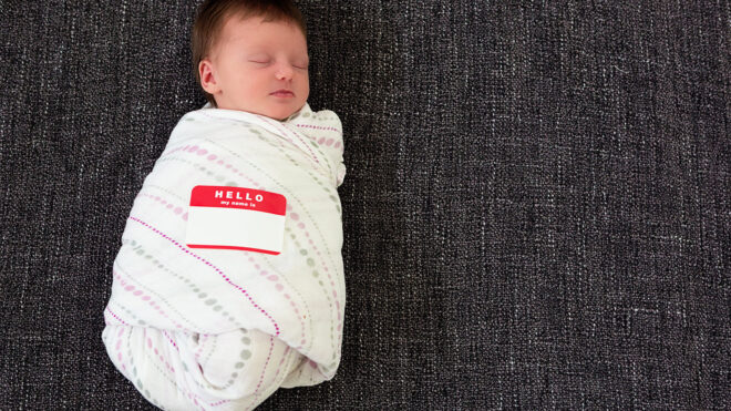 baby with hello my name is name tag