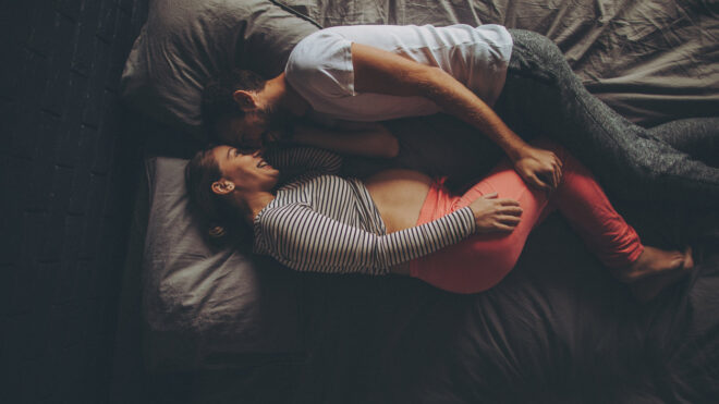 pregnant couple in bed