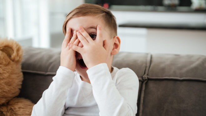 boy covering his eyes