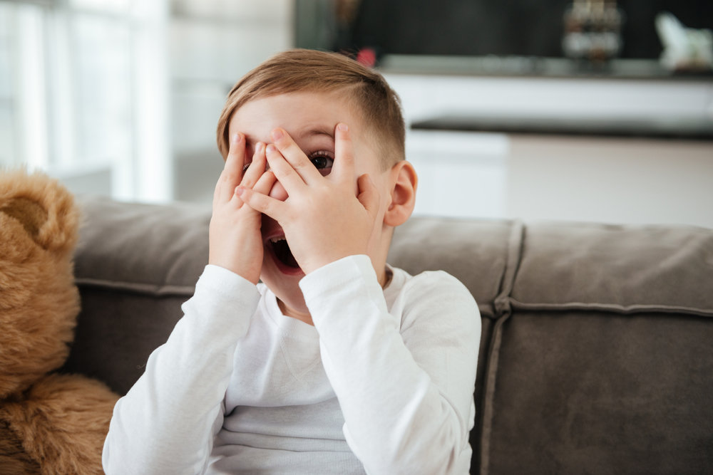 boy covering his eyes