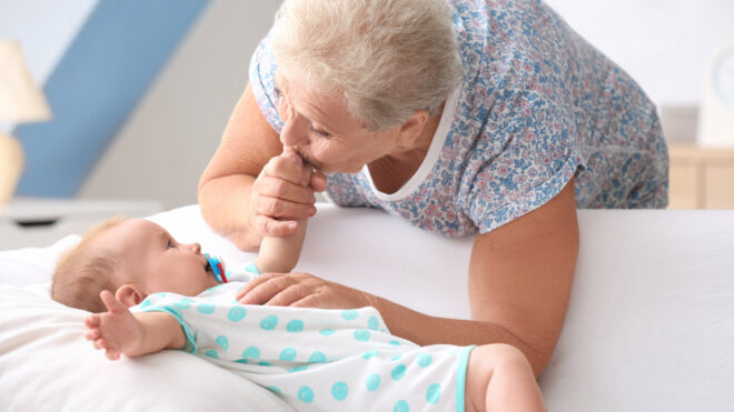 Grandmother kissing baby