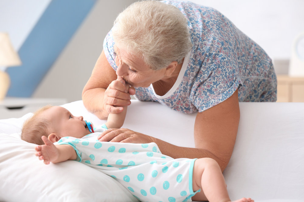 Grandmother kissing baby