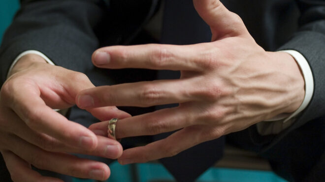 man removing wedding ring