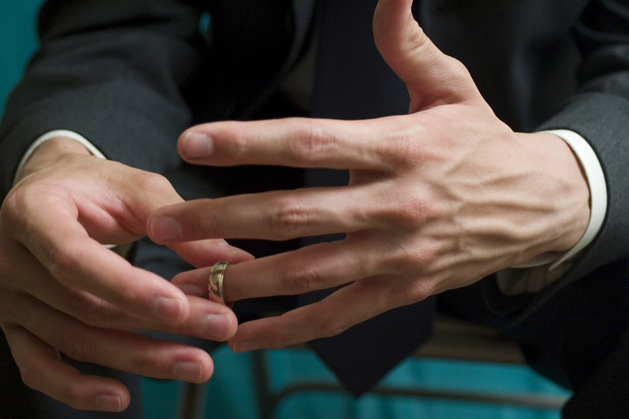 man removing wedding ring
