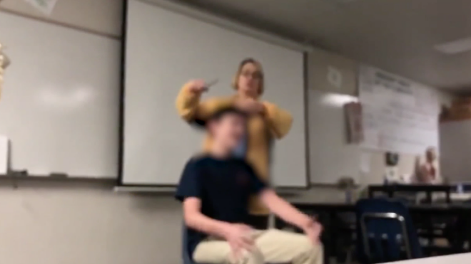 teacher cuts students hair