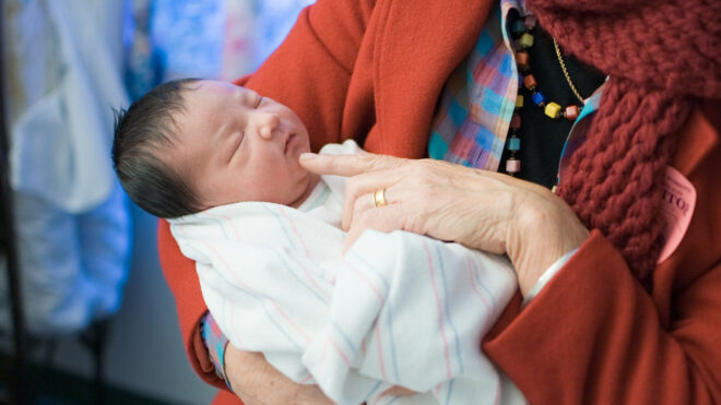 grandma holding new baby