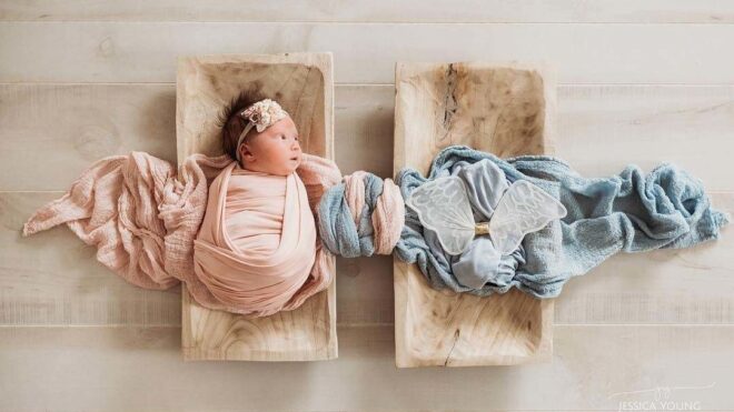 A top-down view of Leti laying in a wooden cradle