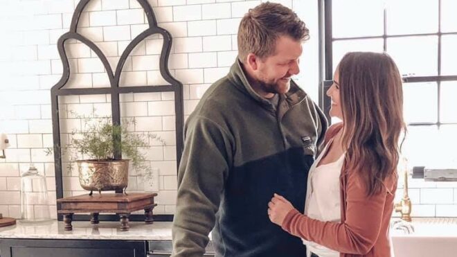 Holly Simon stares lovingly into her husband's eyes while they stand in the kitchen.