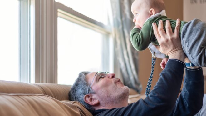 Grandpa holds grandchild