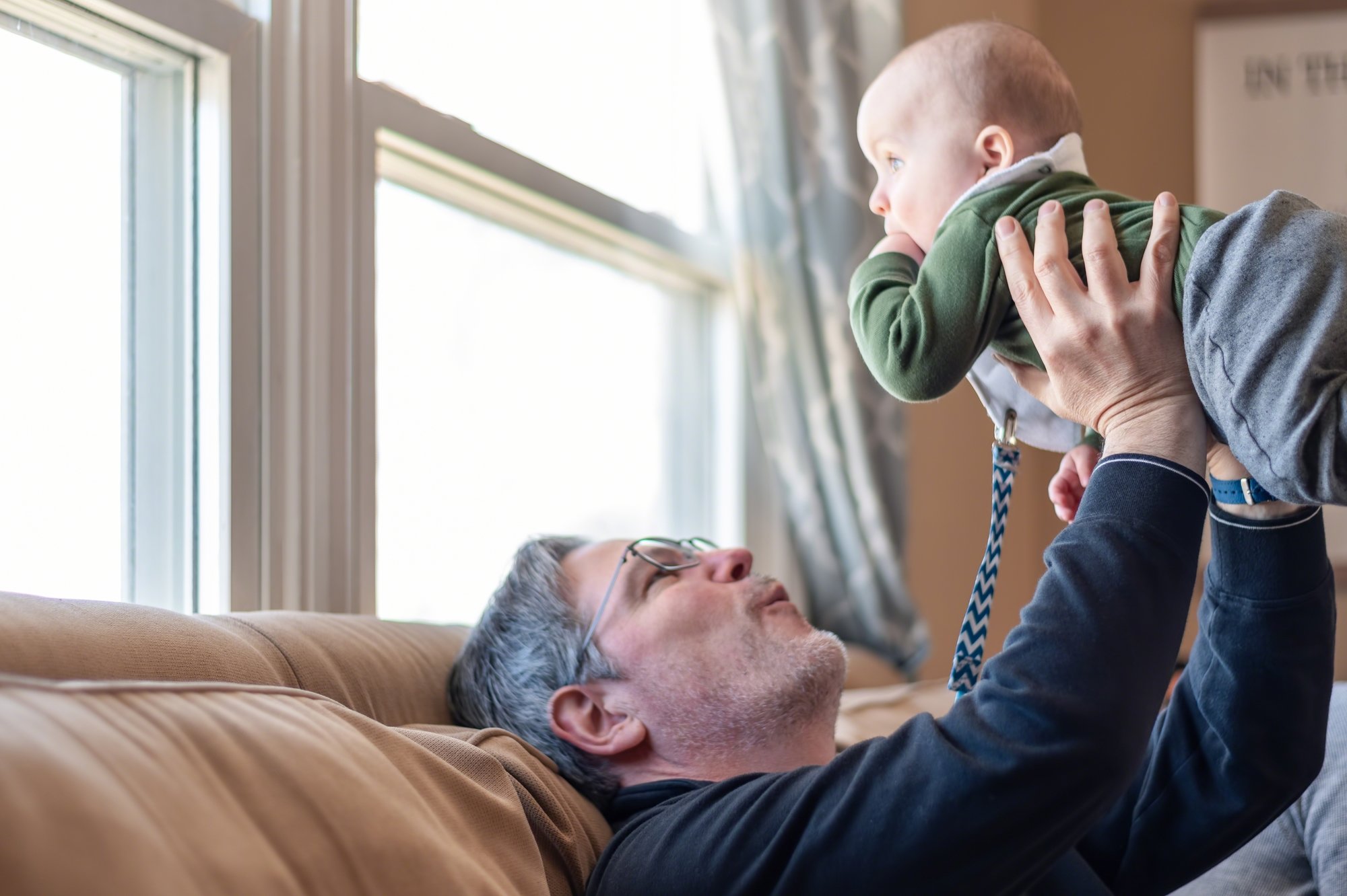 Grandpa holds grandchild