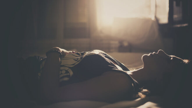 girl laying on bed stock image