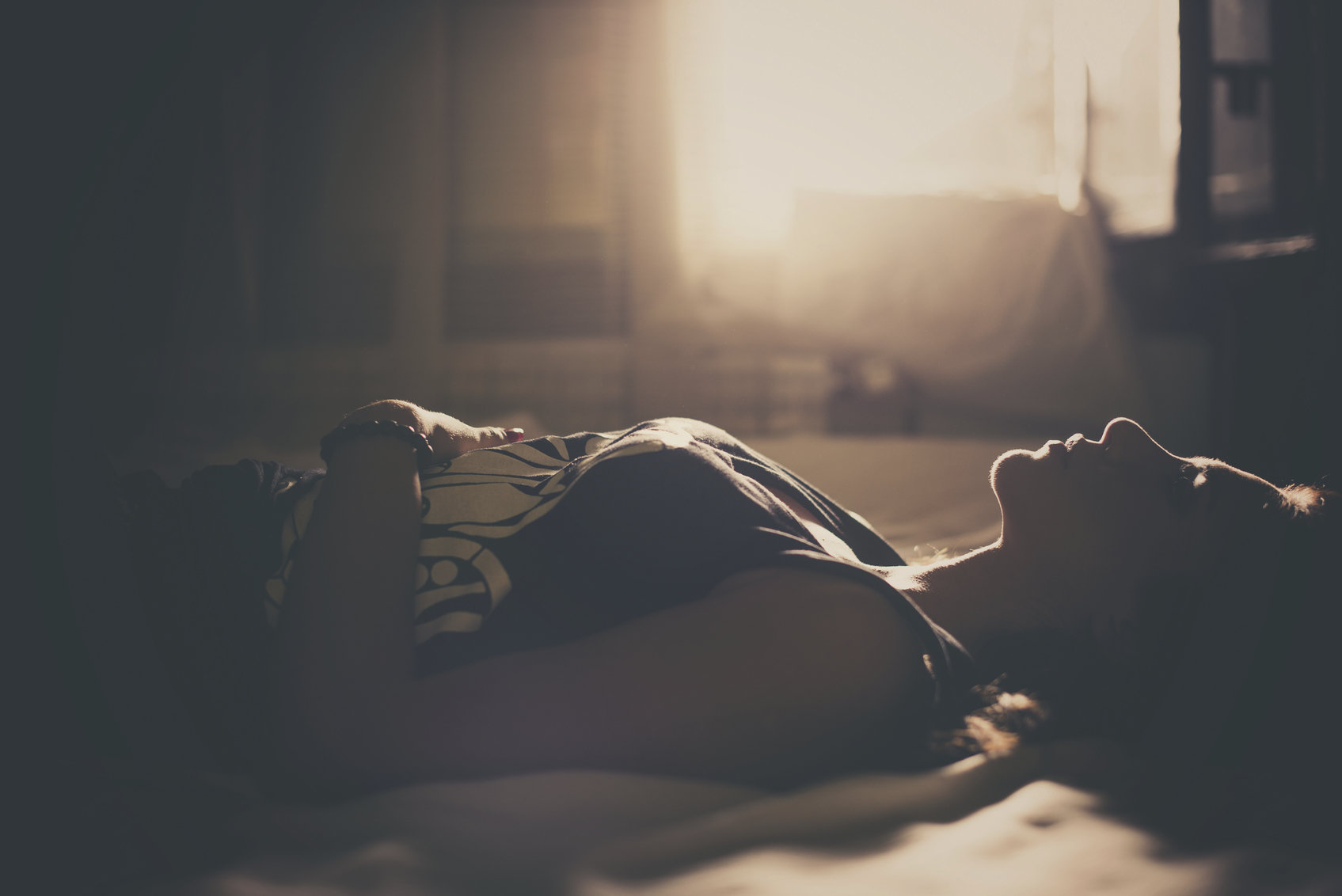 girl laying on bed stock image
