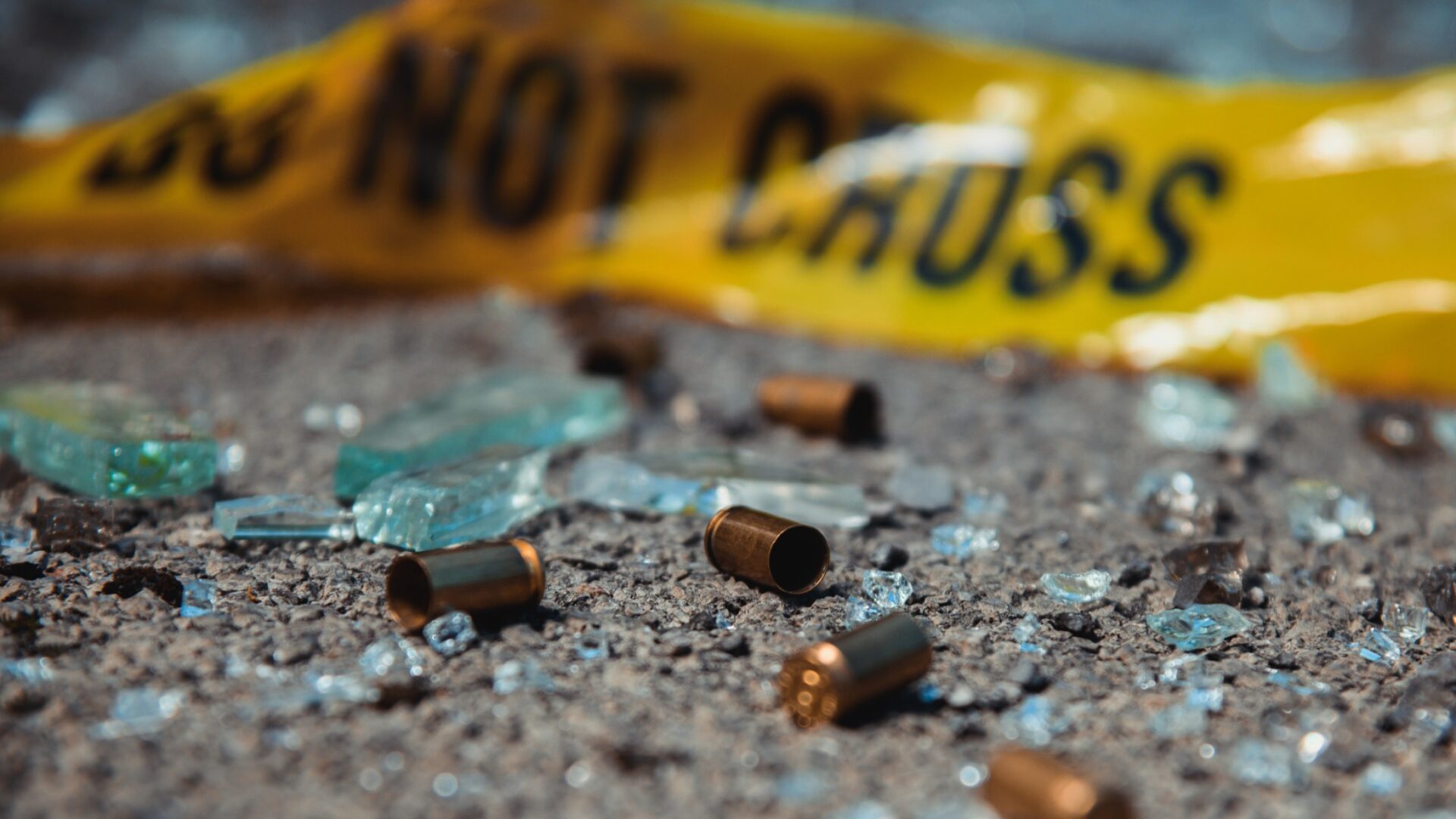 bullets and broken glass police tape