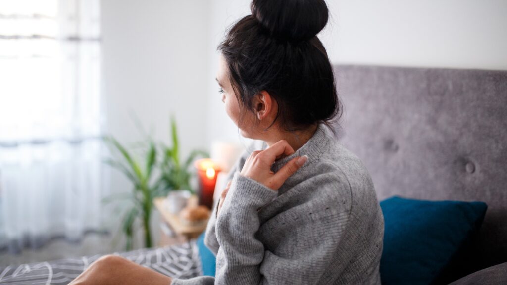 woman upset sitting on bed