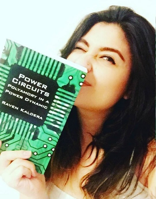 Christina Tesoro holding Power Circuits polyamory book