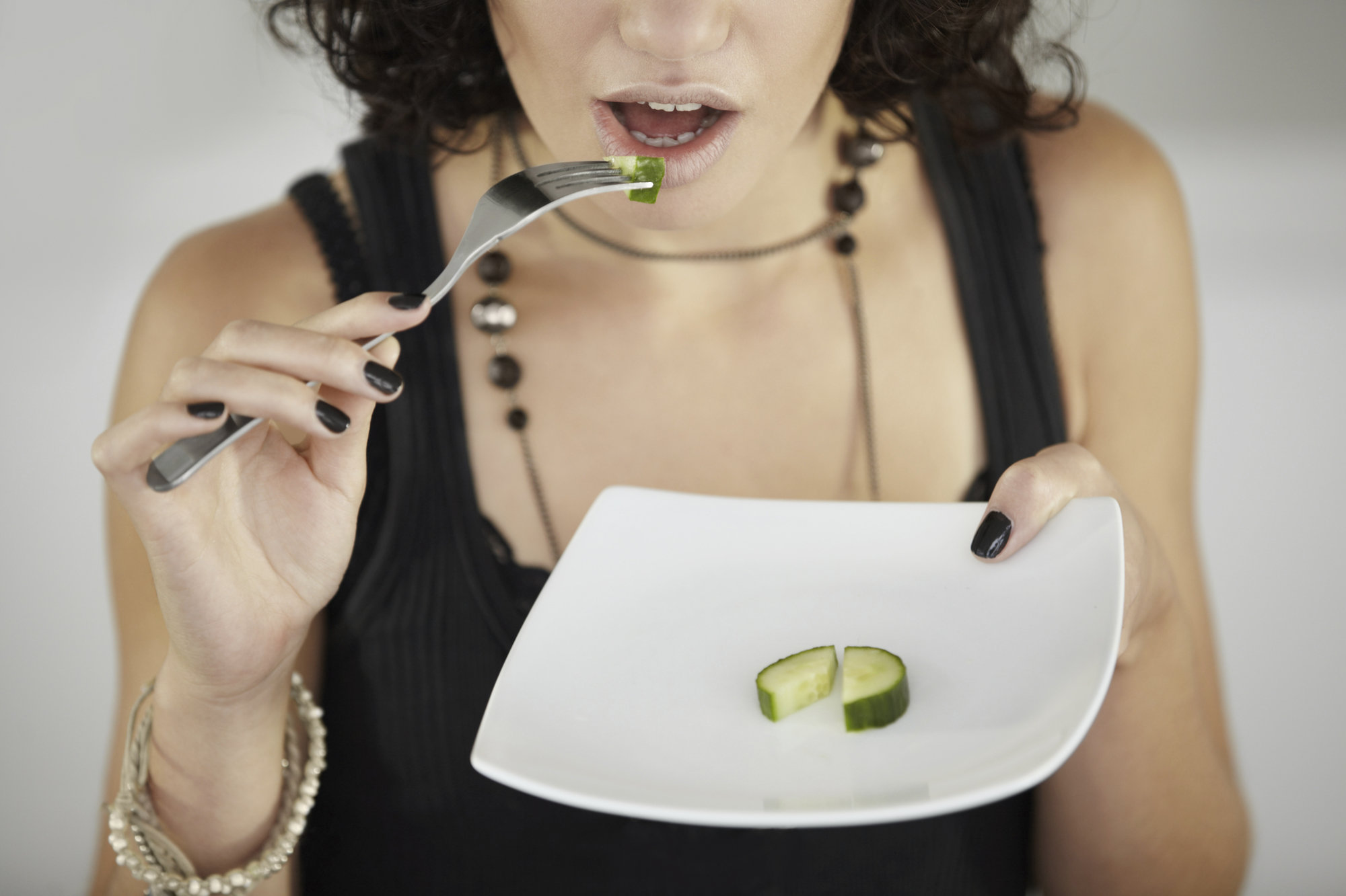woman eating cucumber