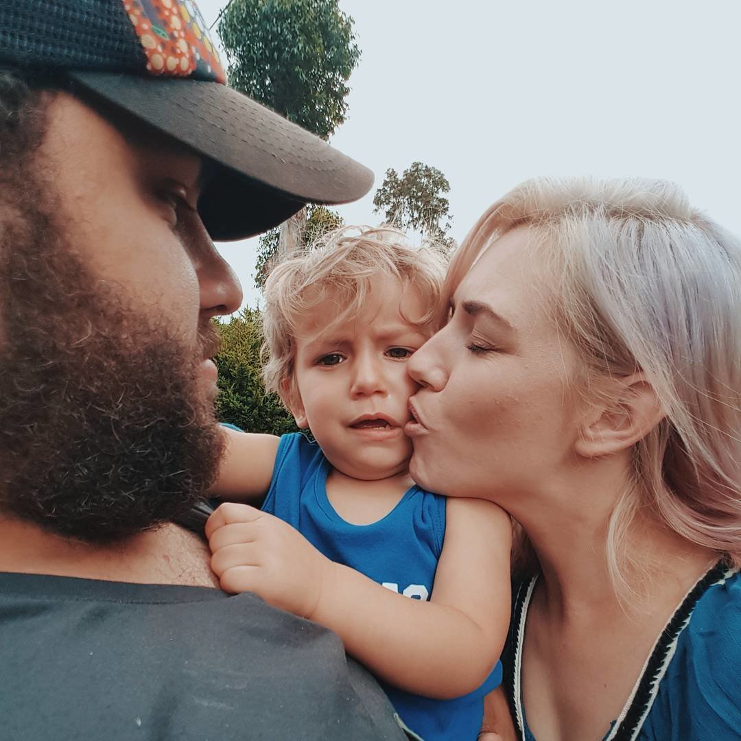 Mom kissing toddler