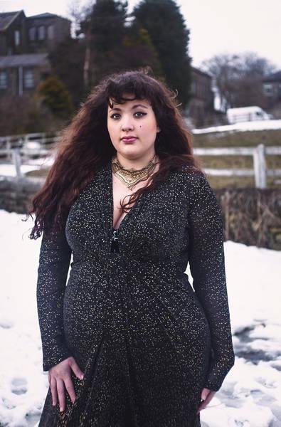 beautiful woman posing in the snow in a coat