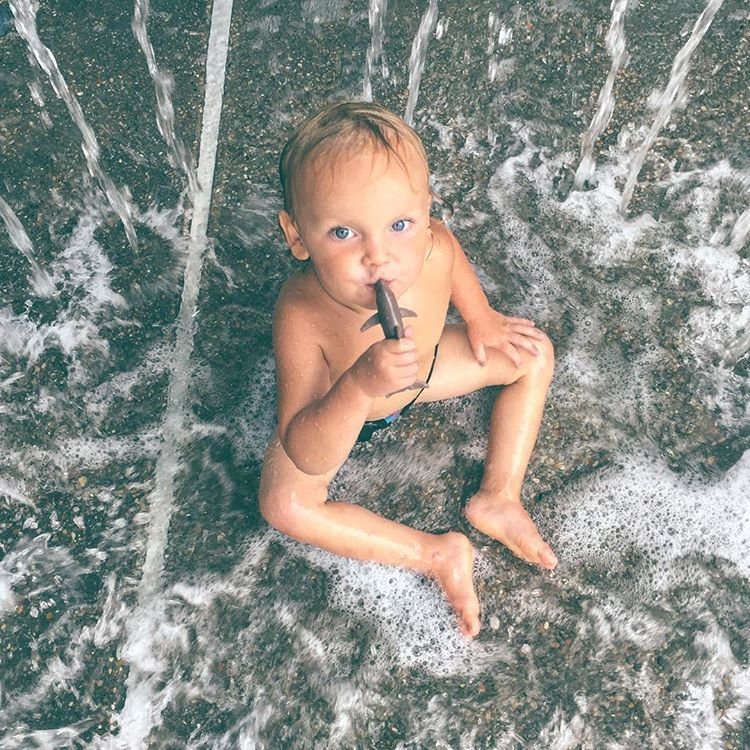 Little boy in sprinkler