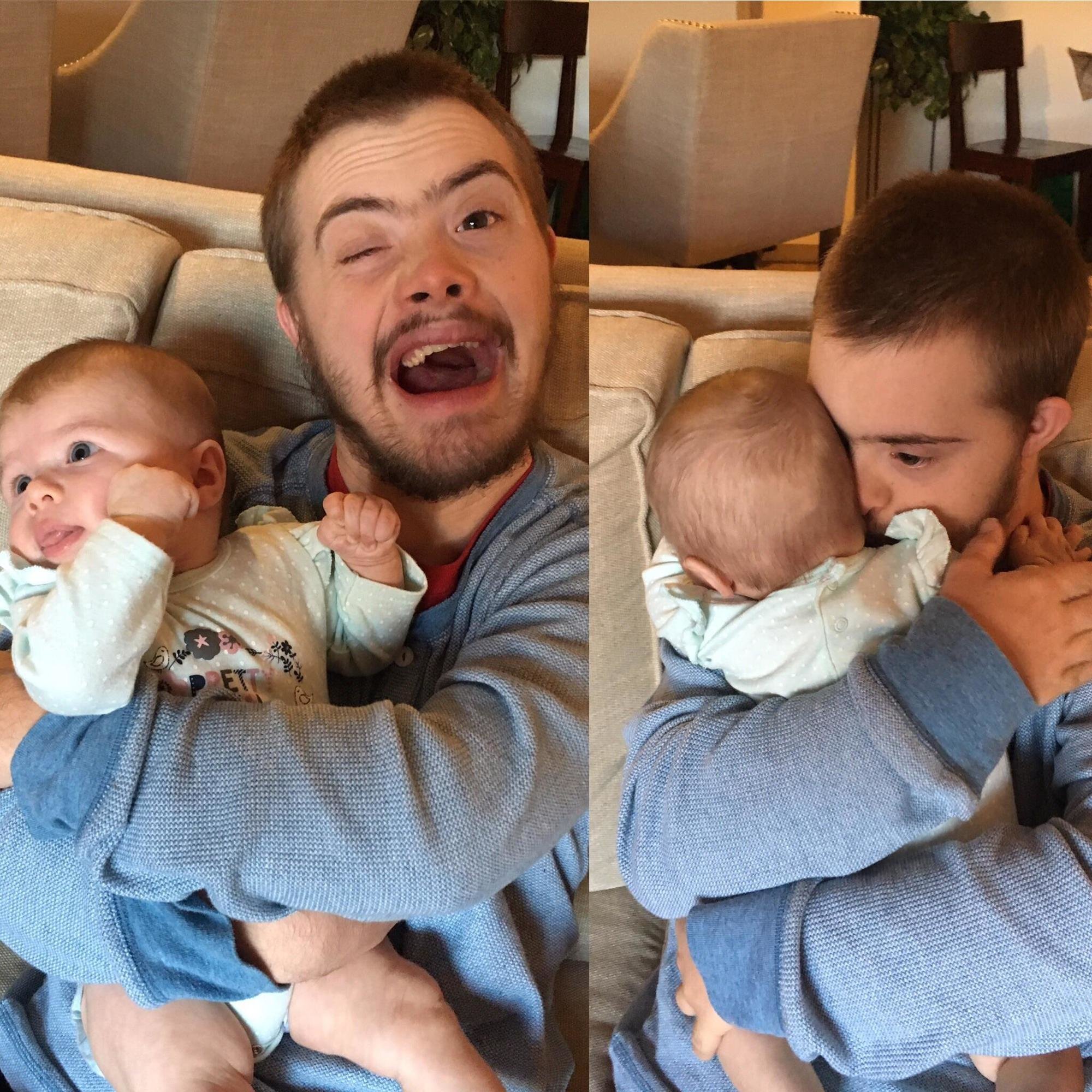 Boy with Down syndrome holding a baby