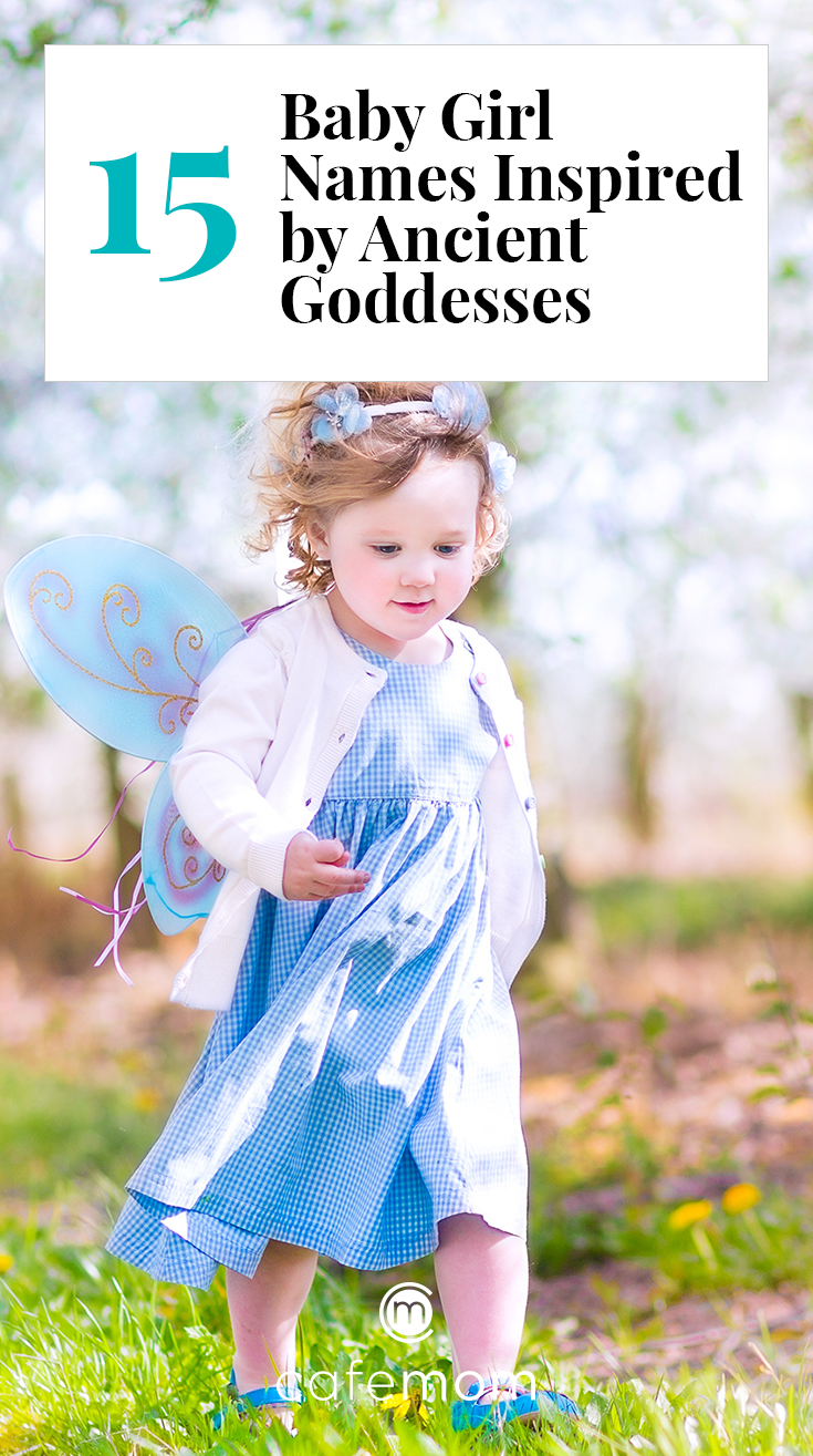 Toddler wearing wings in flower field 