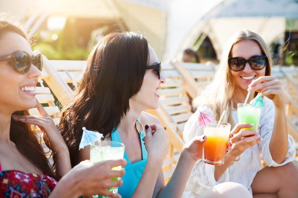 woman drinking on the beach