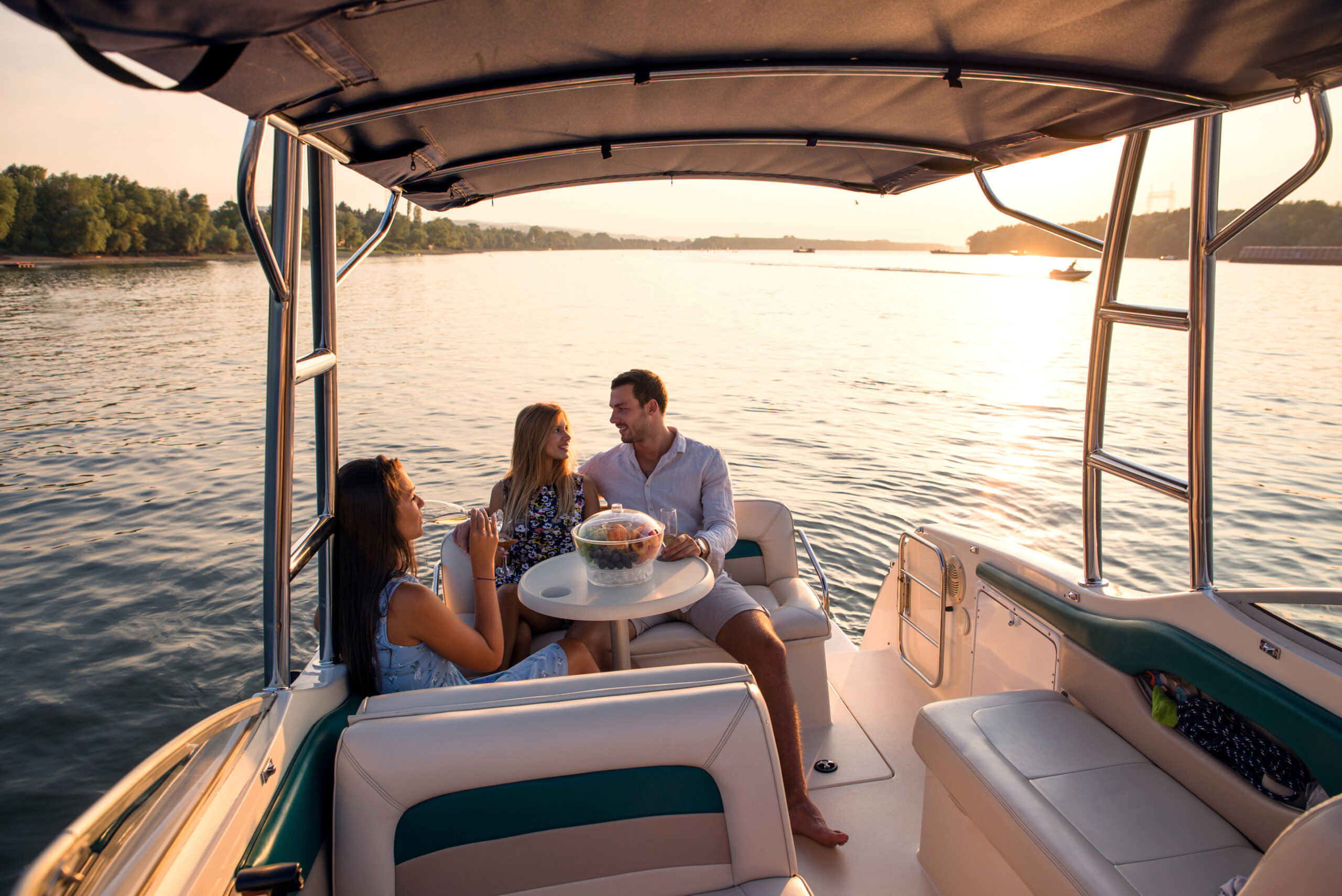 Sunset on a boat, friends are enjoying