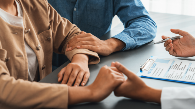 Couple talking to doctor
