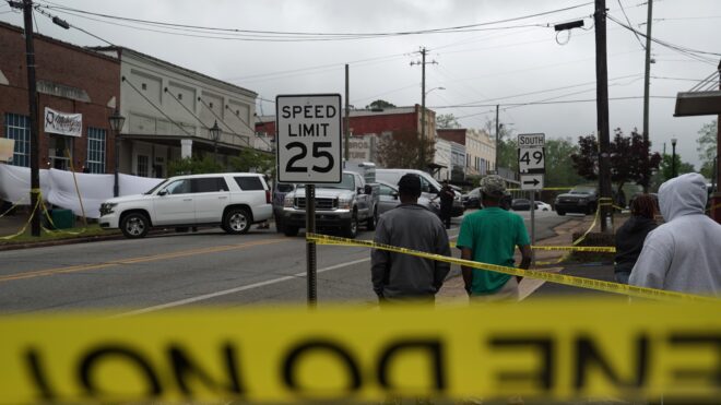 Crime scene investigators work the scene of a shooting April 16