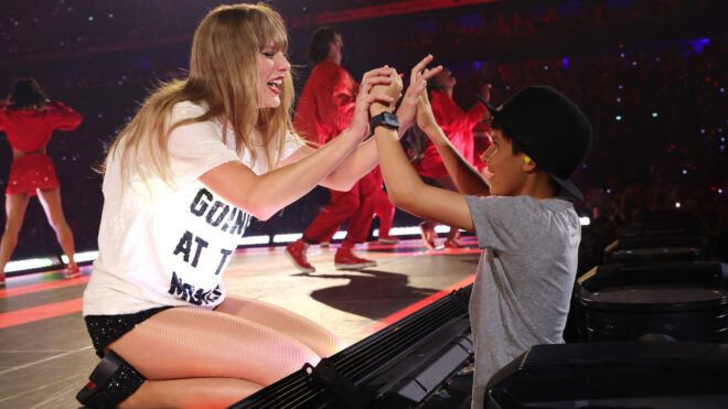 Taylor Swift with a fan while at the Eras Tour