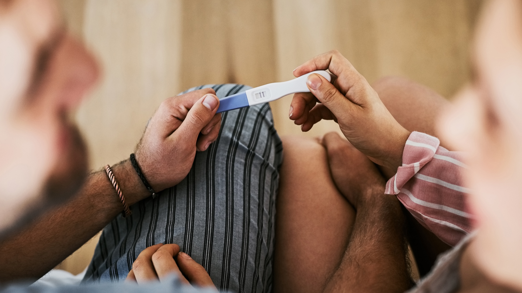 Couple holds positive pregnancy test
