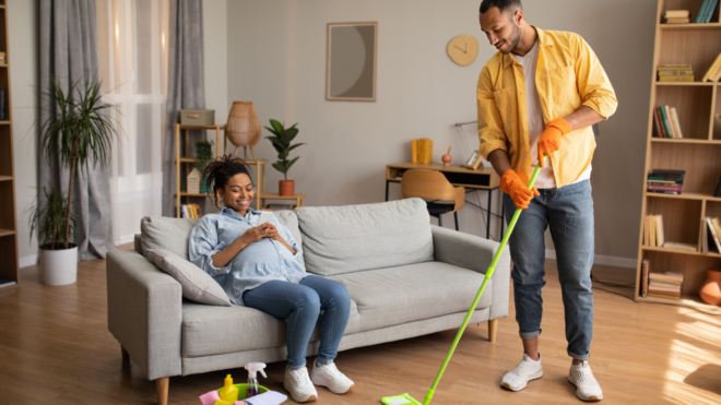 Man doing chores for pregnant wife