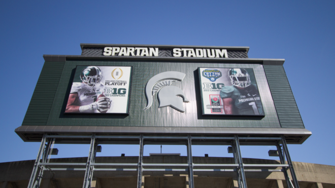 Michigan State University Spartan Stadium signage against a blue sky