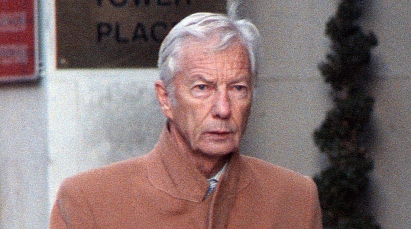 Lester Piggott Wearing A Camel Coat In Chelsea
