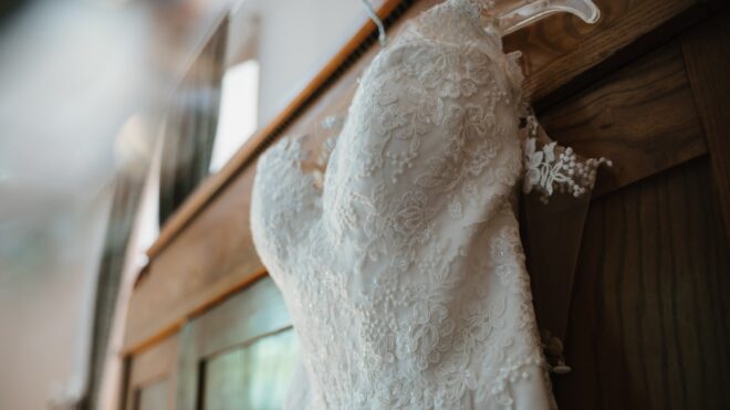 White bridal gown hangs from a hanger