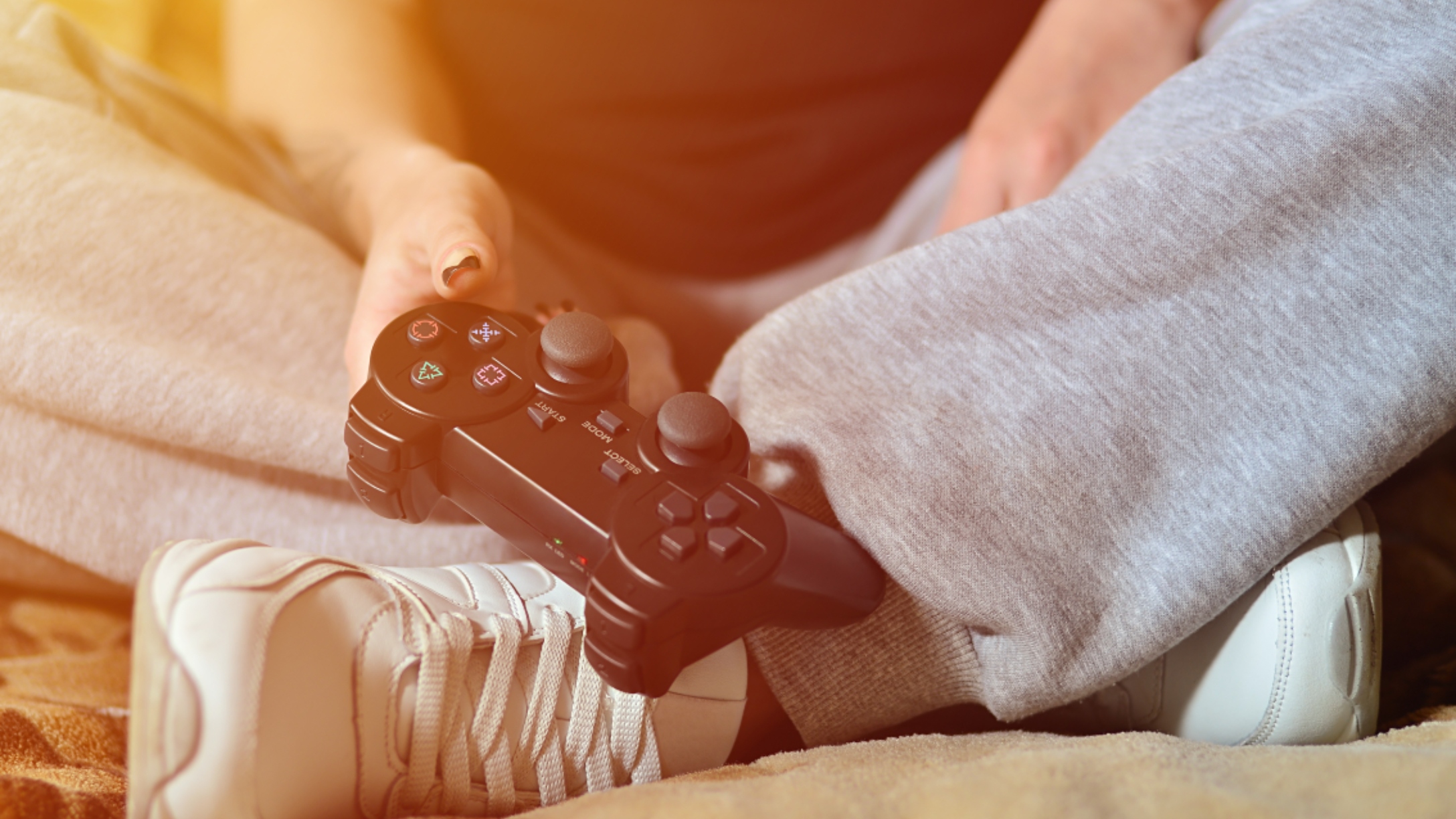 Person holds controller for gaming console