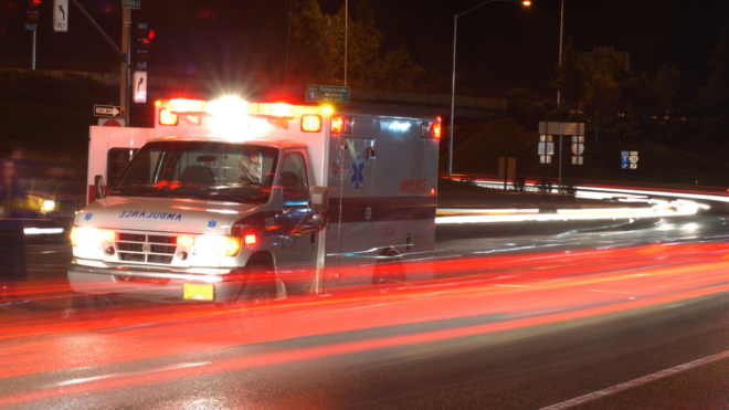 ambulance racing down street with lights on