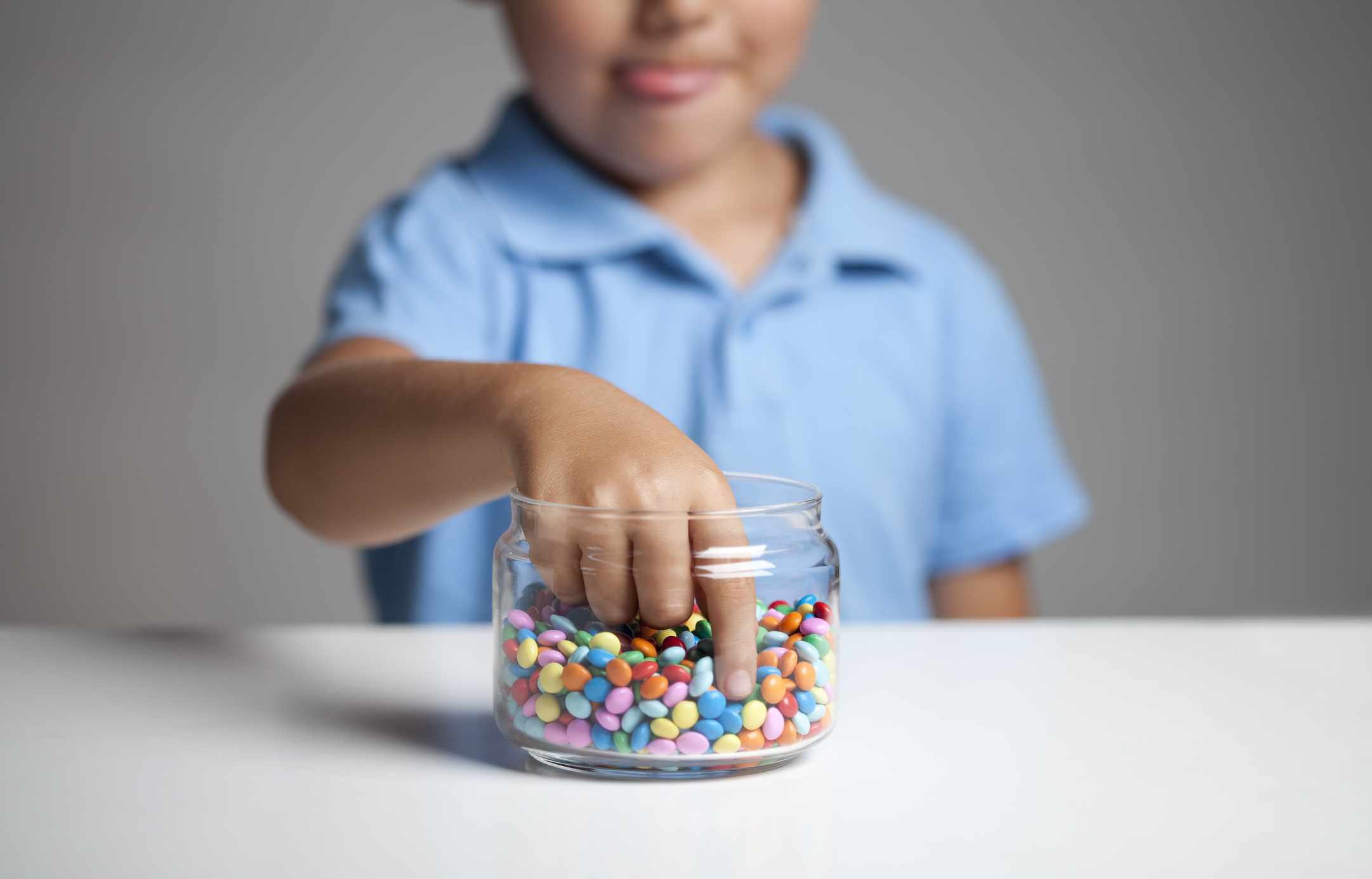 Little boy taking candy from jar Little boy taking candy from jar